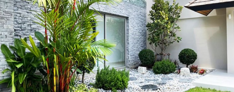 Biệt thự hiện đại với sân vườn được thi công vườn nhiệt đới, kết hợp kính và cây xanh ban đêm.