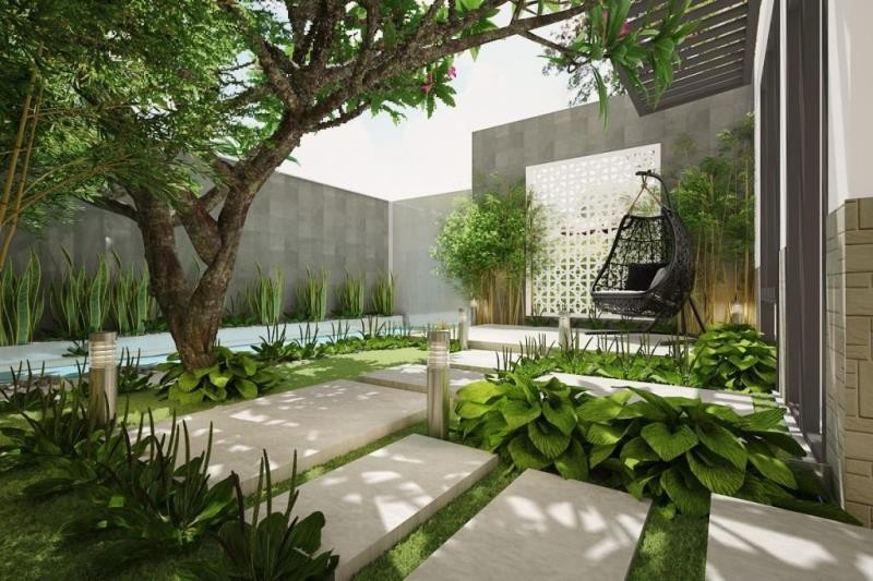 Không Gian Sống Xanh: Tái Tạo Sự Cân Bằng Giữa Thiên Nhiên Và Cuộc Sống 4 Lối đi lát đá giữa không gian sống xanh với cây lớn, bụi cây, ghế thư giãn và ánh sáng tự nhiên chan hòa.