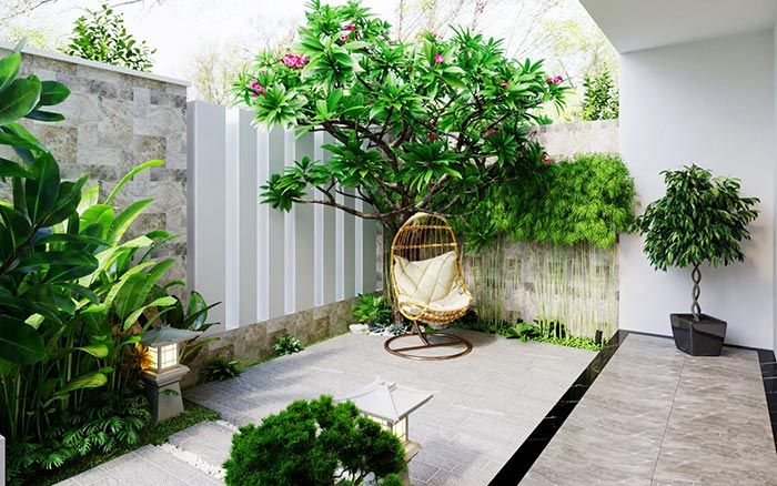 Thiết kế cảnh quan sân vườn nhỏ với cây xanh, ghế treo và đá lát hiện đại