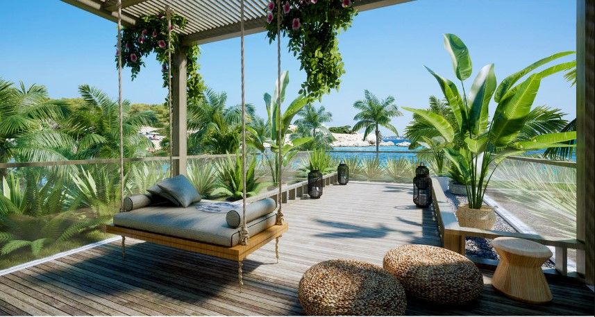 Không gian sân vườn biệt thự nhiệt đới với giường treo, sàn gỗ và cây xanh nhiệt đới nhìn ra biển.